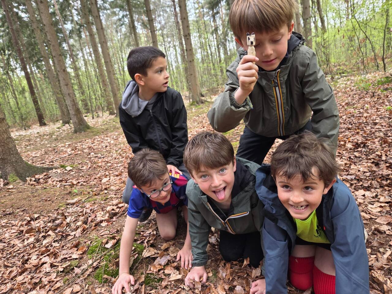 Enfants jouant au jeu de confiance les yeux bandés en forêt